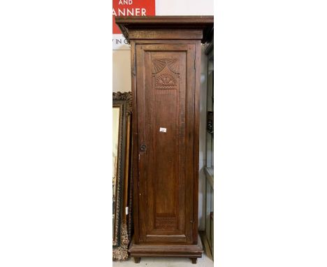Stained oak cupboard with carving detail on the door