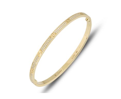 A beautiful 18K yellow gold bangle set with two rows of VS diamonds totalling approx 0.94 carats. The bangle comes with a 18K