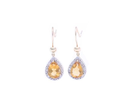 Two gorgeous Citrine gemstones are surrounded by a halo of diamonds in these stunning 9ct yellow gold dandle earrings. Item S