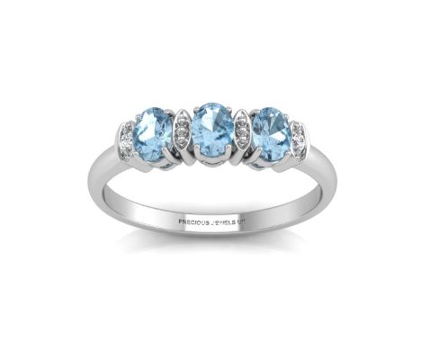 Three oval blue topaz gemstones are set with two round diamonds in between to create this classic three stone ring. Item Spec