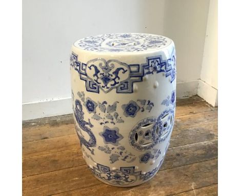 A modern Chinese style porcelain verandah stool of drum form, with pierced panel sides and top, decorated with dragon design 