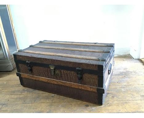 A late 19thc metal and oak bound rectangular travelling trunk with twin handles to side and faux crocodile embossed case (32c