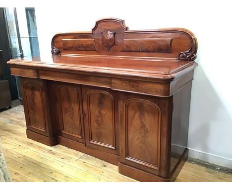 A Victorian mahogany ledgeback sideboard, the rectangular top with moulded edge above an arrangement of three frieze drawers 