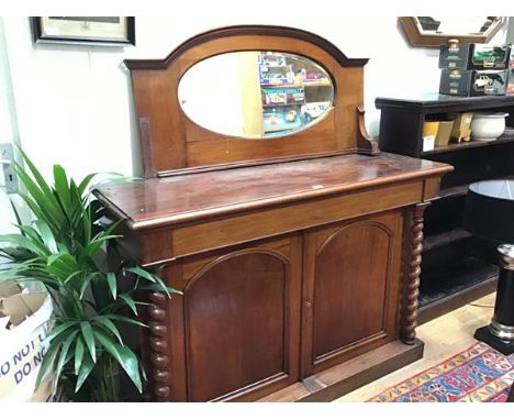 A Victorian credenza base, the rectangular top with moulded edge above a single frieze drawer and twin arched panel doors, fl