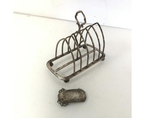 A Gothic style Victorian London silver toastrack (a/f) (12cm x 13cm x 7cm) and a silver decanter label presented to John Gedd