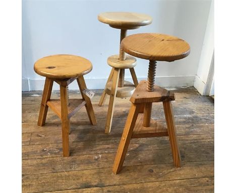 A pair of pine circular adjustable stools raised on tripod splay supports (44cm (fully extended: 62cm) x d.29cm)and a similar
