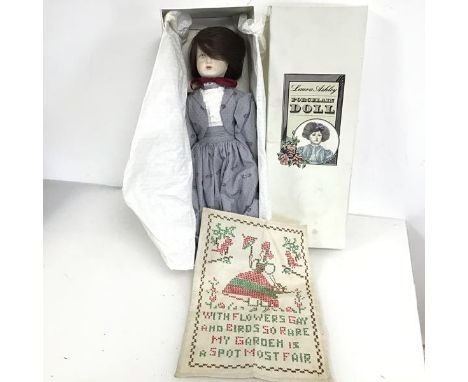 A Laura Ashley porcelain doll (38cm) with original box, and an embroidered panel with Girl and Poem (2)