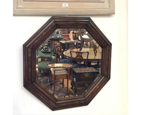 A 1920s oak octagonal moulded frame wall mirror with bevelled glass plate (d.80cm)