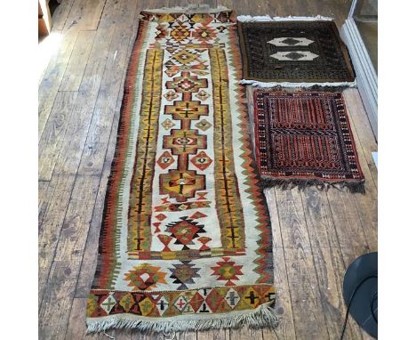A kelim flatwoven runner, the centre panel with four stylised medallions enclosed within a geometric border, cream field (211