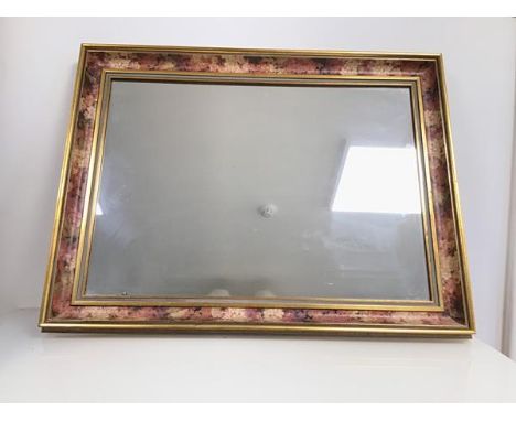 A modern wall mirror with gilt and painted frame