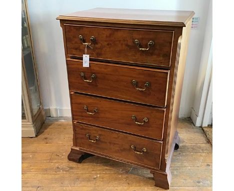 An Edwardian tallboy chest, the rectangular top with moulded edge above four long drawers with fluted canted corners raised o