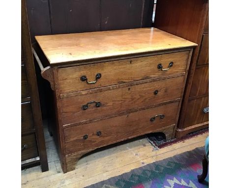An Arts &amp; Crafts oak chest, the rectangular top with moulded edge above three graduated long drawers, with towel rail tur