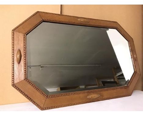 An octagonal wall mirror with bevelled glass, the frame with beaded edges (54cm x 85cm)