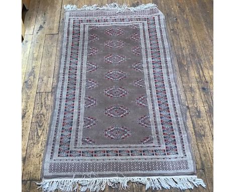 A Belouch rug, the centre panel with seven octagonal medallions enclosed within a stylised diamond, leaf and flower multiple 