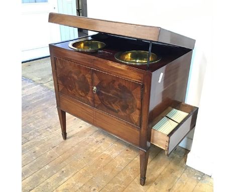 A 19thc mahogany washstand, the rectangular hinged top enclosing a fitted interior complete with two brass circular wash bowl