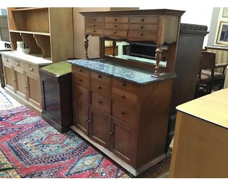 A French walnut buffet, the top with an arrangement of three sets of drawers, raised on turned supports with mirror panel bac