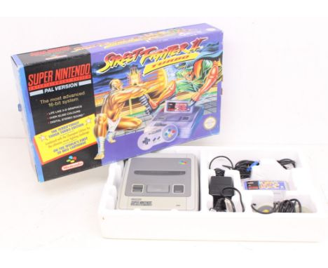 Nintendo: A boxed Super Nintendo Entertainment System (SNES) console, complete with power supply, controller, and instruction