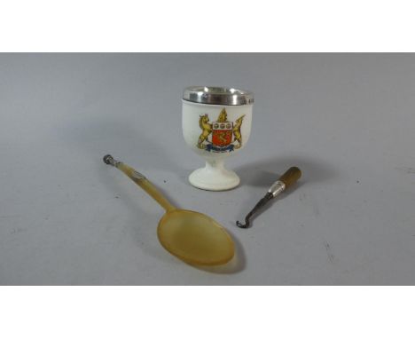 A Silver Mounted Crested Ware Eggcup, a Silver Mounted Scottish Horn Teaspoon and a Silver Mounted Button Hook 