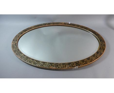 A Large Oval Wall Mirror With Bevelled Glass, 81cm high 