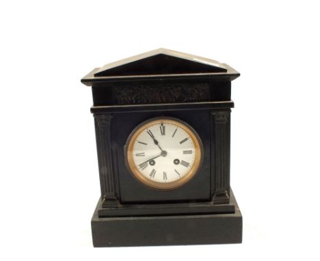 A black marble striking mantel clock