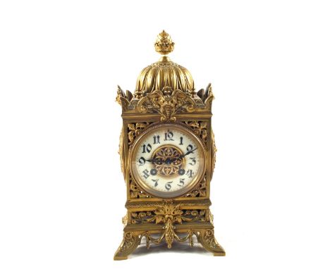 A French mantel clock with enamel dial in pierced Brass case