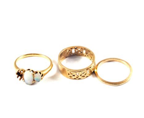 A 9ct Gold pierced band ring, a small 9ct Gold band ring with a Gold Opal set ring (missing one stone)