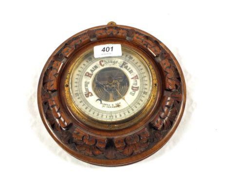 A circular carved Mahogany barometer