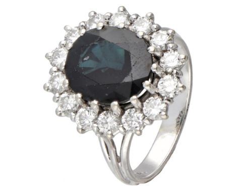 Hallmarks: 750. Set with a faceted natural sapphire (approx. 10.5 x 8.7 mm) and 10 brilliant cut diamonds of approx. 0.70 ct.