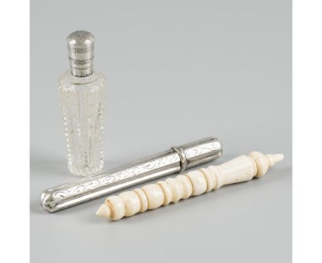 Comprising a diamond-cut glass perfume bottle with silver cap and original glass stopper and two needle cases, one of which i