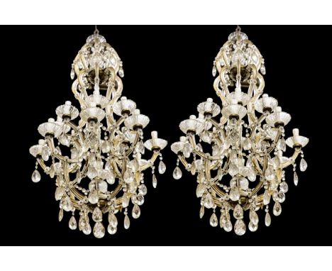 Each 17-light, with metal frame covered with glass, with glass pendants, rosettes and drip pans.