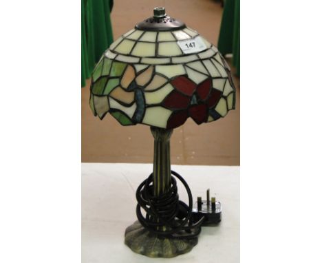 A small Tiffany style table lamp with floral shade.