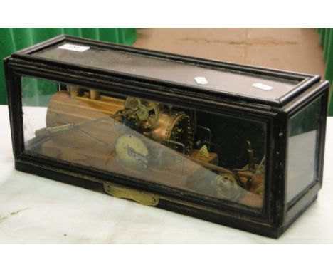 A cased scratch-built model of a steam engine.