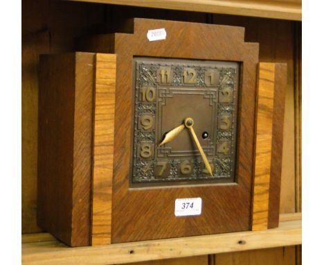 An Art Deco inlaid oak mantel clock.