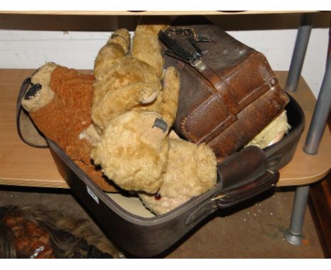 2 Teddybears and a doll, a clock movement and a small Gladstone bag.