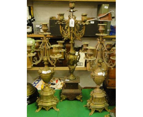 A pair of continental 5-branch candelabra and another with foliate design on plinth, and a Menora.
