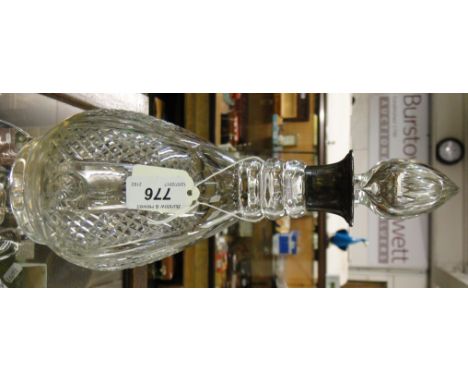 A cut-glass decanter with silver collar.