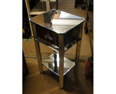 A mirrored glass side table with single drawer and shelf below.