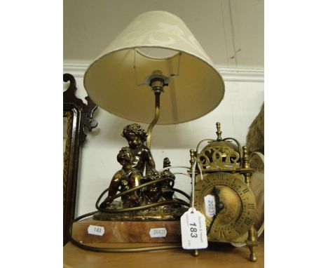 A Brass lantern clock, & a table lamp with cherub support