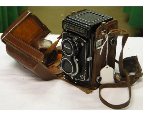 A Ricoh Diacord leather cased camera.