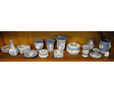 A shelf of Wedgwood blue Jasperware boxes and vases, etc.