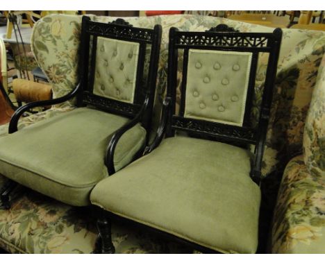 Pair of ebonised Aesthetic Movement side chairs,with carved & pierced upholstered backs, raised on ring turned legs, probably