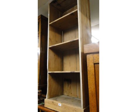 An Antique narrow polished pine open book shelf.