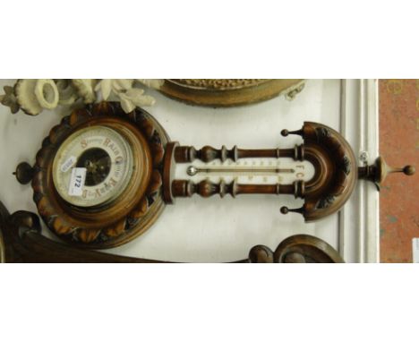 A carved walnut cased aneroid barometer