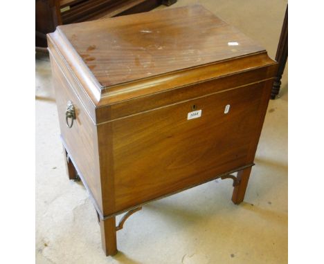 A reproduction mahogany sarcophagus cellarette, with lion mask ring handles on square tapered legs.