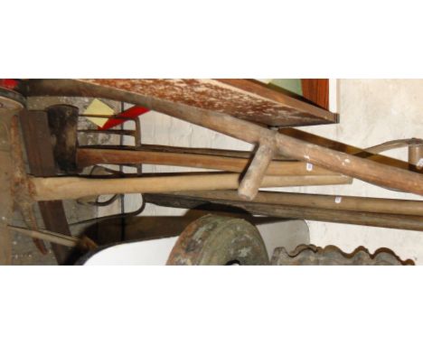 Collection of Vintage long handled gardening tools including a scythe, pick axe, pitchfork, etc.