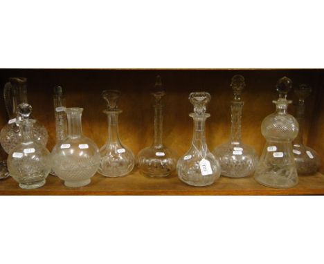 A shelf of cut-glass decanters and stoppers.