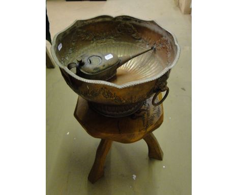 Carved wood stool, a large copper bowl with ring handles and an oil can.