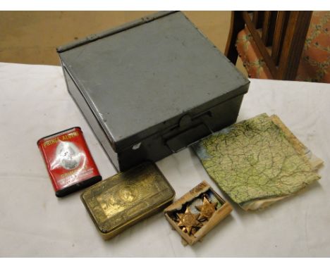 A tin with First World War Queen Mary's Christmas tin, a silk map of Northern France and other First World War items includin