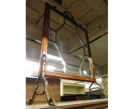 A mahogany framed firescreen with bevelled mirrored panels, Arts & Crafts brass mounts.