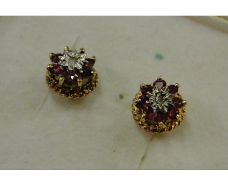 Pair of 9ct gold ruby and diamond set stud earrings.